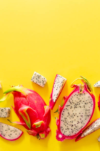 istock Slices of fresh white pitaya or dragon fruit on yellow background, flat lay 1708360507