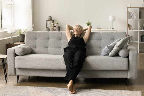 istock Peaceful happy senior lady resting on couch with closed eyes 1708362751