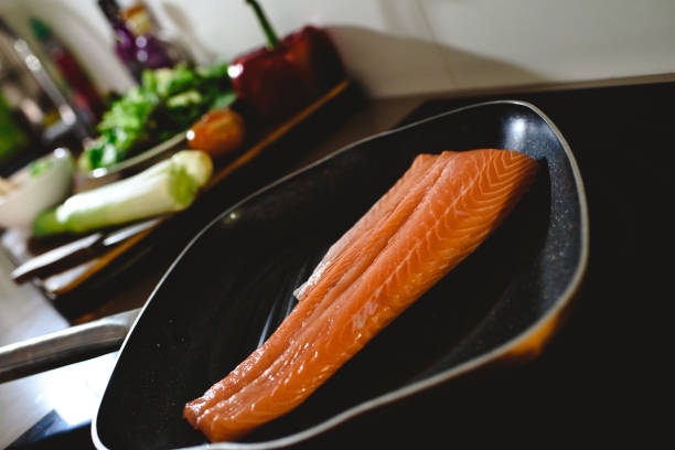 Pink salmon fillet in a frying pan before cooking it.