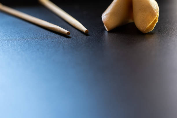 istock Fortune cookies on black background with chopsticks and copy space. 1708387069