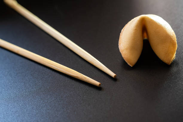 istock Fortune cookies on black background with chopsticks and copy space. 1708392065