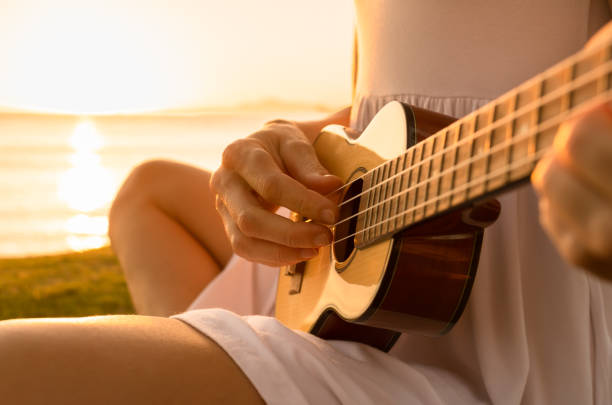 istock Woman playing ukulele on the beach in Hawaii. 1708401569
