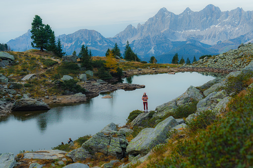 Young Caucasian woman standing on the background of Alpine lake  in Austria