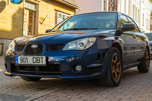 Pärnu, Estonia - September 03 2023: Blue Subaru Impreza 2006 parked in Parnu Old town on a sunny autumn day.