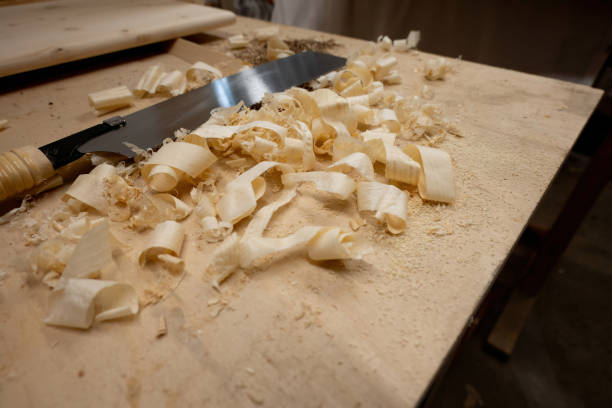 istock Hand saw with wooden chips on table. 1708432600