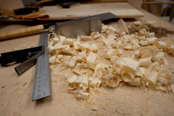 istock Joiner's right angle, plane and hand saw with wooden chips on table. 1708432608