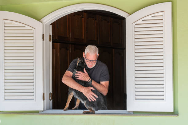 istock man with dog at home 1708437429