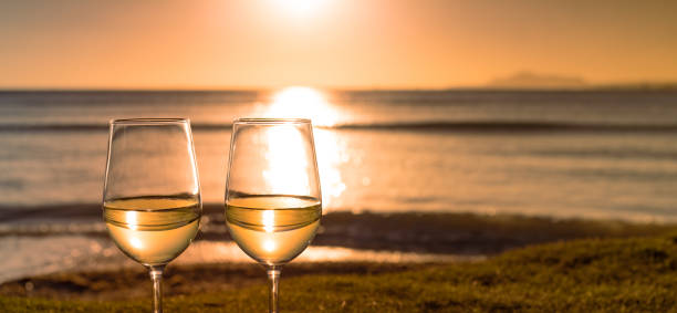 istock Pair of wine glasses and ocean sunset view. 1708447058