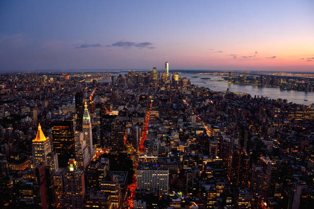 New York City Skyline seen from the Empire State Building at Dusk View from the top of the Empire State Building in Manhattan, New York City, featuring the Hudson River and the One World Trade Center. new york life building stock pictures, royalty-free photos & images