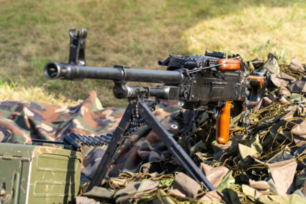 istock Soviet-made PK machine gun and camouflage netting.. 