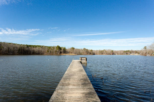 istock Relaxing Old Wood Pier Over Lake in Fall with Blue Sky 1708466642
