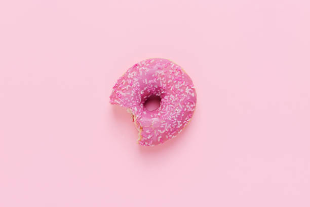 istock Top view of one pink donut on a pink background 1708469165
