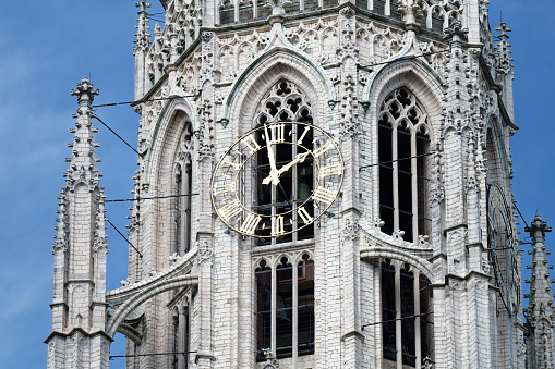 the gothic church tower with church clock of the protestant onze-Lieve-Vrouwekerk in breda