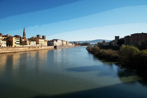 View on river Arno with buildins and park Dell' Alconello on another side in Florence
