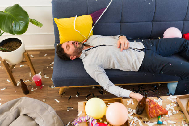 istock Passed out drunk man unconscious on the sofa after a night drinking 1708551107