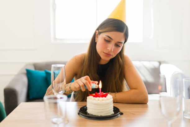 istock Depressed young woman celebrating her birthday alone making a wish 1708551131