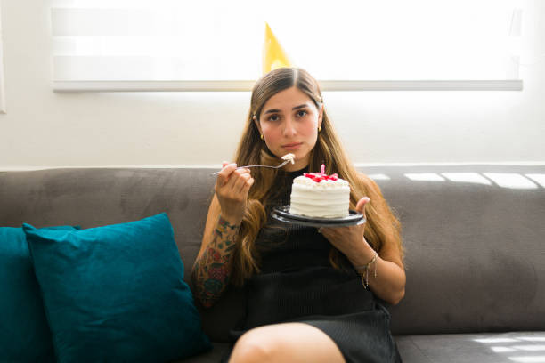 istock Sad young woman eating her birthday cake alone 1708551644