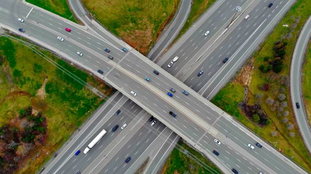 istock Drone flies over track during traffic with many interchanges in different directions with large number of cars that move one after another and change lanes to desired exit from city. traffic concept 1708555895