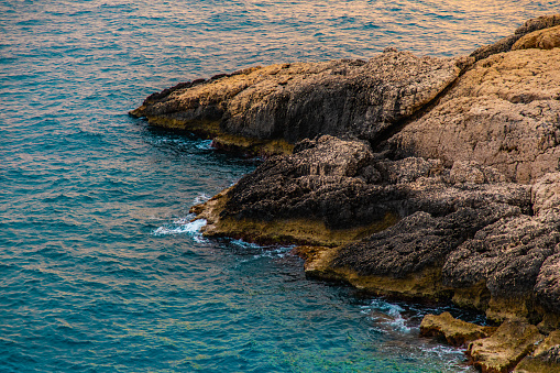 View of the sea and rocks at sunset time. Aegean coasts. Sea waves and nature that look like heaven.