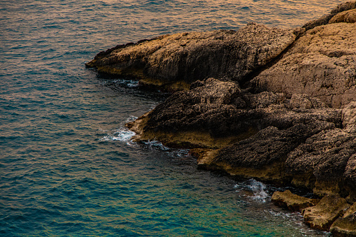 View of the sea and rocks at sunset time. Aegean coasts. Sea waves and nature that look like heaven.
