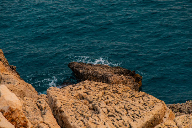 View of the sea and rocks at sunset time. Aegean coasts. Sea waves and nature that look like heaven.