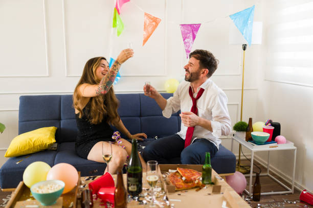 istock Happy couple cheering drinking shots at the party 1708562585