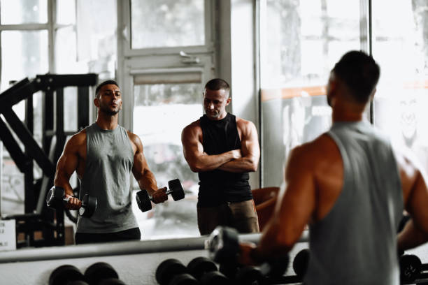 istock Bicep Workout By Two Bodybuilders In Gym 1708589422