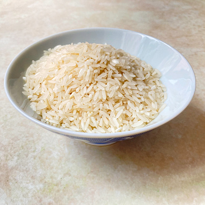 Close-up view of raw white rice in a bowl
