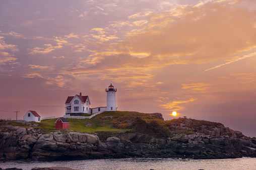 Lighthouse on an island in the ocean at dawn. USA. Maine. Nubble Lighthouse