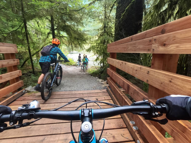 Diverse Multiracial Group of Mountain Bikers Gathering at River Viewpoint