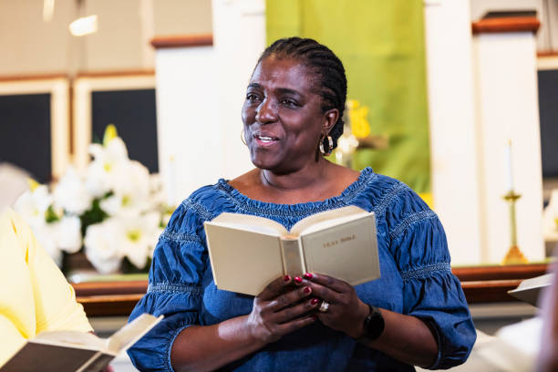 istock Mature black woman in group bible study 1708662104