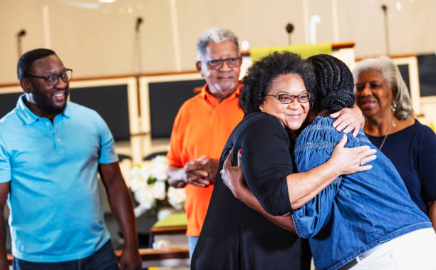 Black senior woman smiling and hugging friend