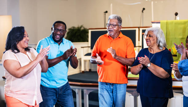 istock Group of black friends standing  in circle clapping 1708663169