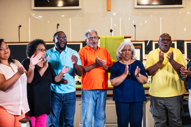 istock Black men and women standing, clapping and singing 1708663179