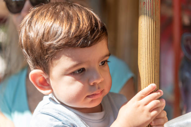 istock Close up view of a little boy on a carousel. 1708690221