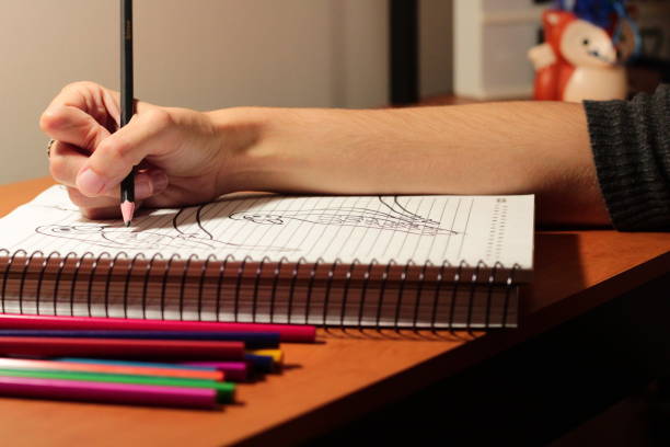 istock Girl Drawing Birds with Colored Pens in her Notebook 1708720662