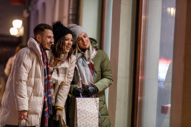 istock Three joyful friends window shopping during Christmas holidays 1708795143
