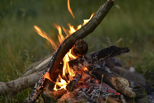 mountaineer traveling in nature, lighting a campfire, hiking, sitting and resting