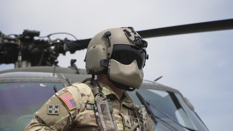 Military soldier in front of landed helicopter on battle field, slow motion