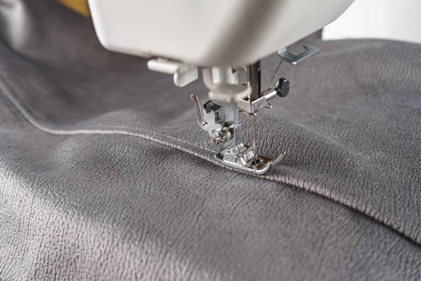 istock Modern sewing machine with gray velours fabric close up 1708869500