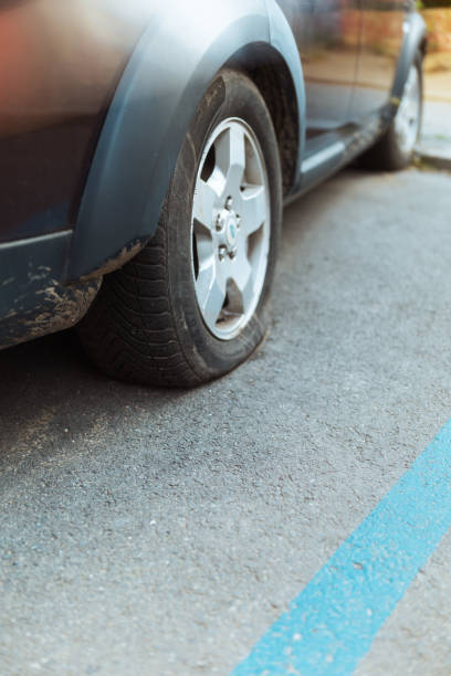 istock Closeup on car with flat tire in city 1708870716
