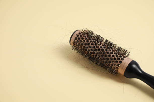 istock Professional brush with lost hair on beige background, closeup. Space for text 1708872633