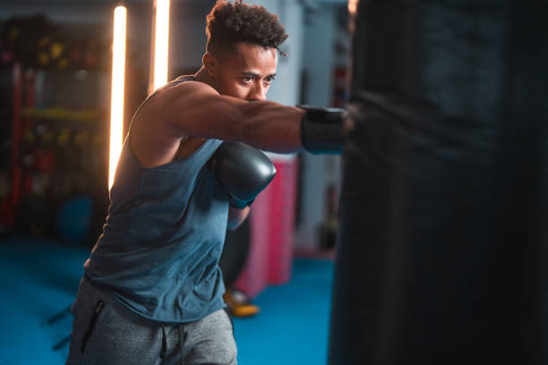 istock Strong African American Professional Male Boxer Exercising Alone 1708877313