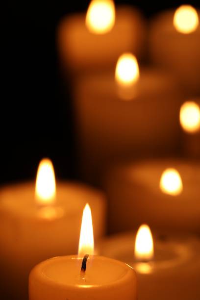 istock Burning candles on black background, closeup. Space for text 1708885266