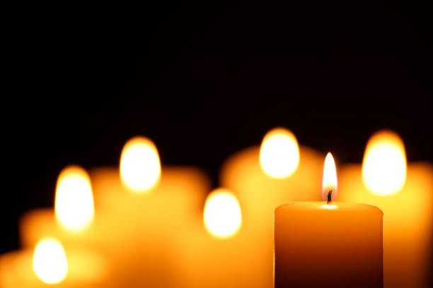 istock Burning candle on black background, closeup. Space for text 1708885989