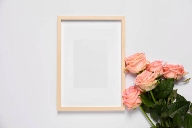 istock Empty photo frame and beautiful flowers on white background, top view. Space for design 1708896094