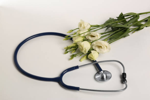 istock Stethoscope and eustoma flowers on white background. Happy Doctor's Day 1708897208
