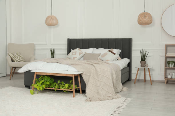 istock Stylish bedroom interior with large comfortable bed and armchair 1708897216