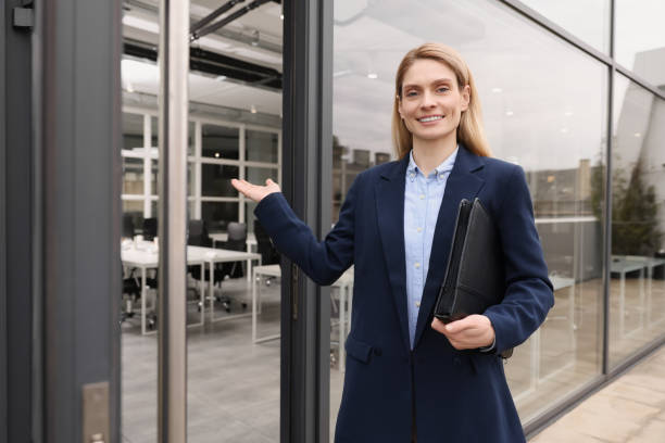 istock Female real estate agent with leather portfolio inviting inside 1708943115