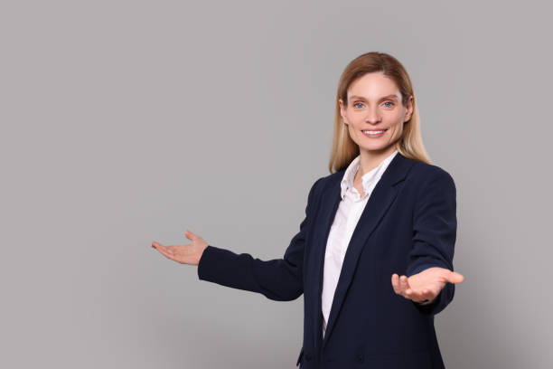 istock Happy real estate agent on grey background. Space for text 1708943703